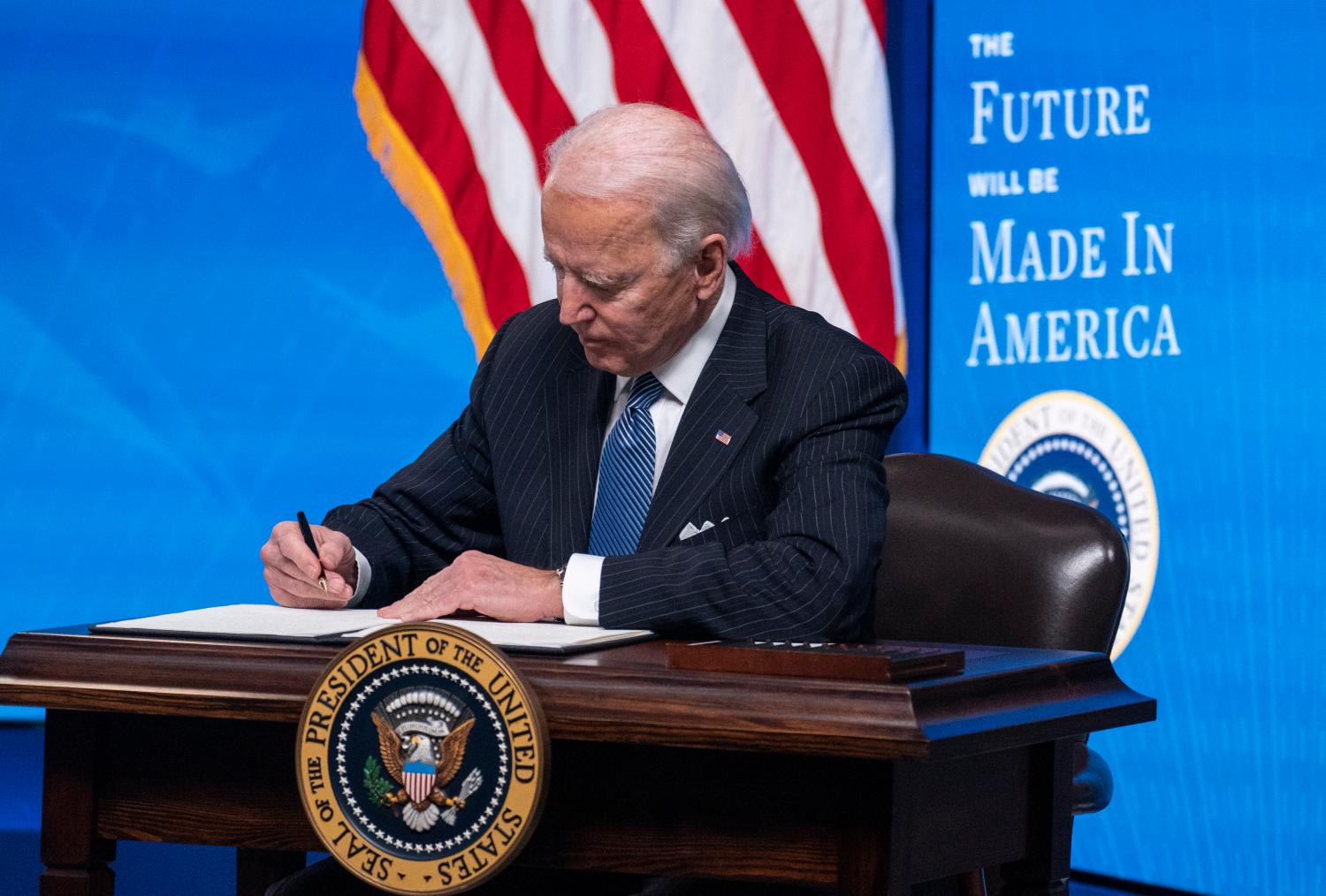 President Joe Biden signs an executive order related to American manufacturing and American workers.