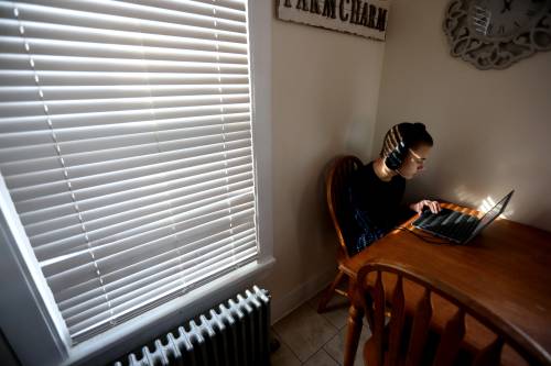 Jordan Jansen, 12, does school work at the kitchen table in his family's Middletown home Jan. 25, 2021. The Jansen's four school aged children are doing full time virtual learning as their parents have opted to keep them home for the entire school year due to COVID-19 concerns.Learning Curve
