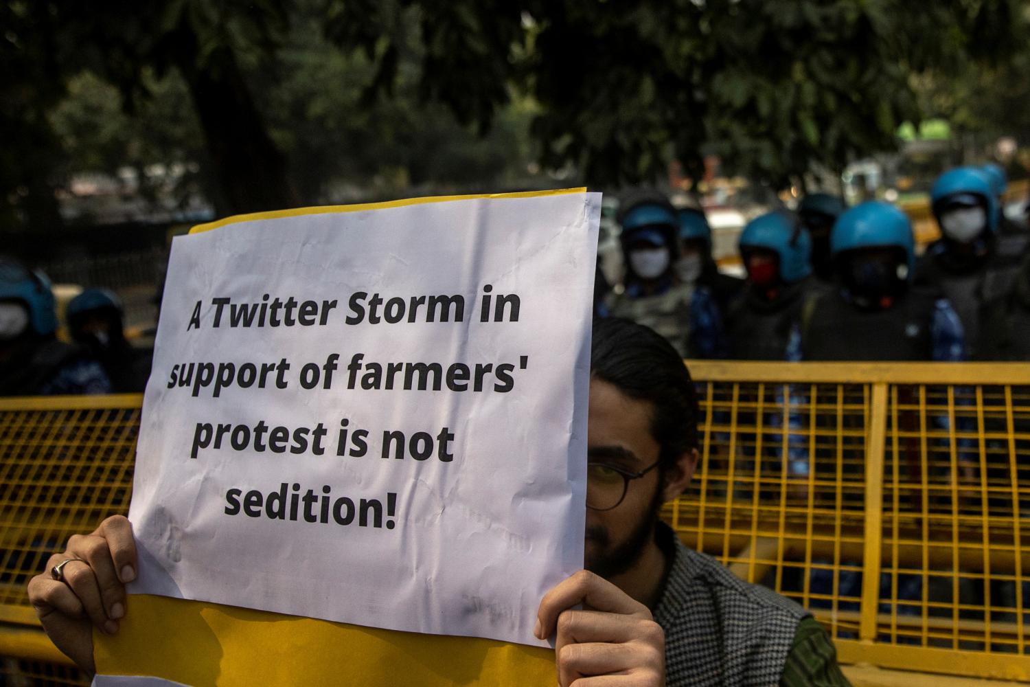 A demonstrator holds a placard during a protest against the arrest of 22-year-old climate activist Disha Ravi,  outside the police headquarters in New Delhi, India, February 16, 2021. REUTERS/Danish Siddiqui