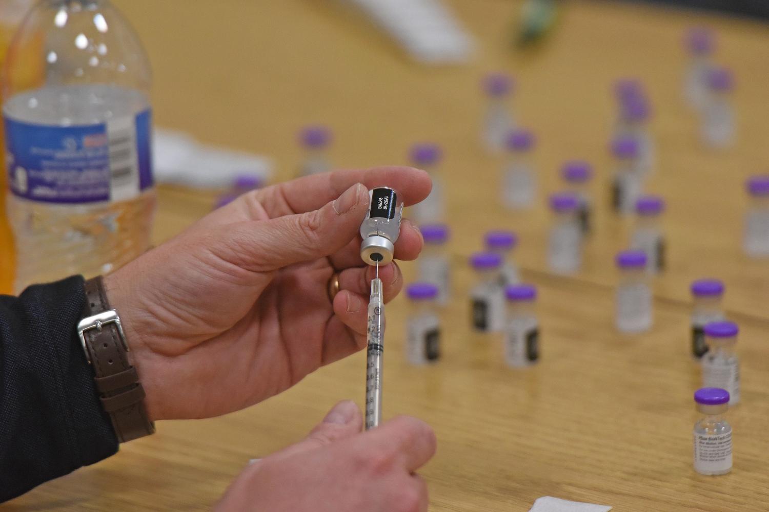 Area school staff members receive a COVID-19 vaccination Friday at the Mid-Ohio Education Service Center .Dsc 9625