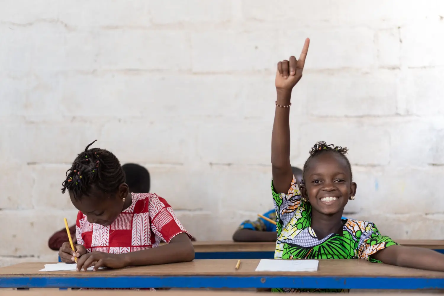 Two girls study in a classroom.