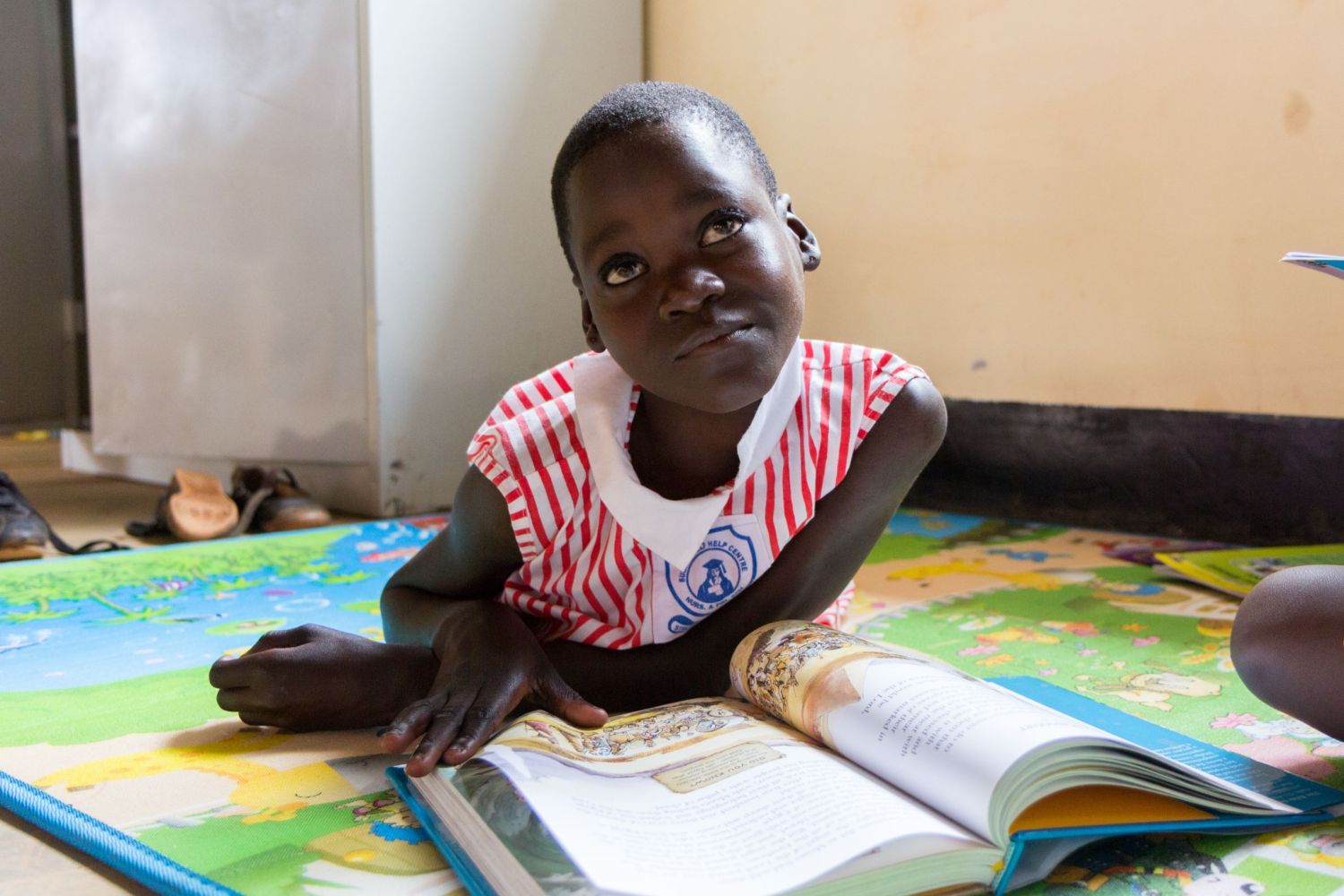 A girl in Uganda reads a book.