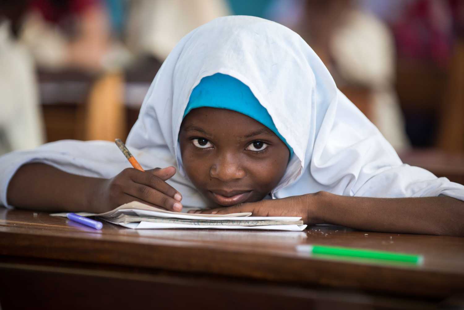 A girl studies at her desk.