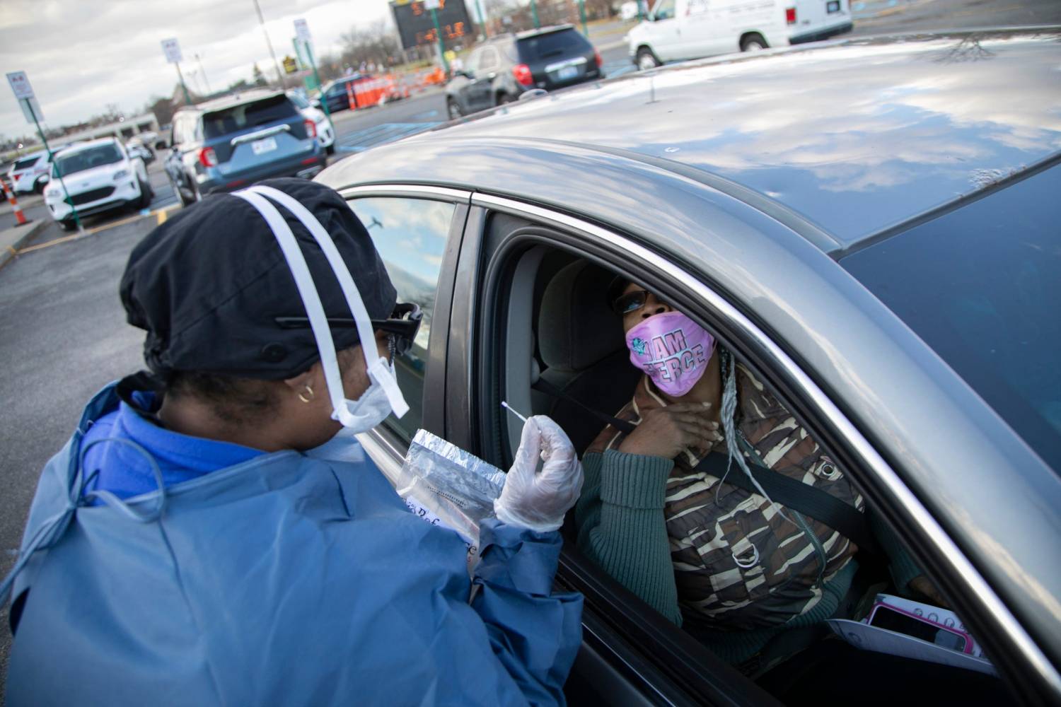 Ebone Jolly RN, prepares to administer a Covid-19 test to Shu Rice, 59, of Detroit in the parking lot at The Joseph Walker Williams Community Center Friday Nov. 13, 2020.Covidtesting 111320 15 Mw