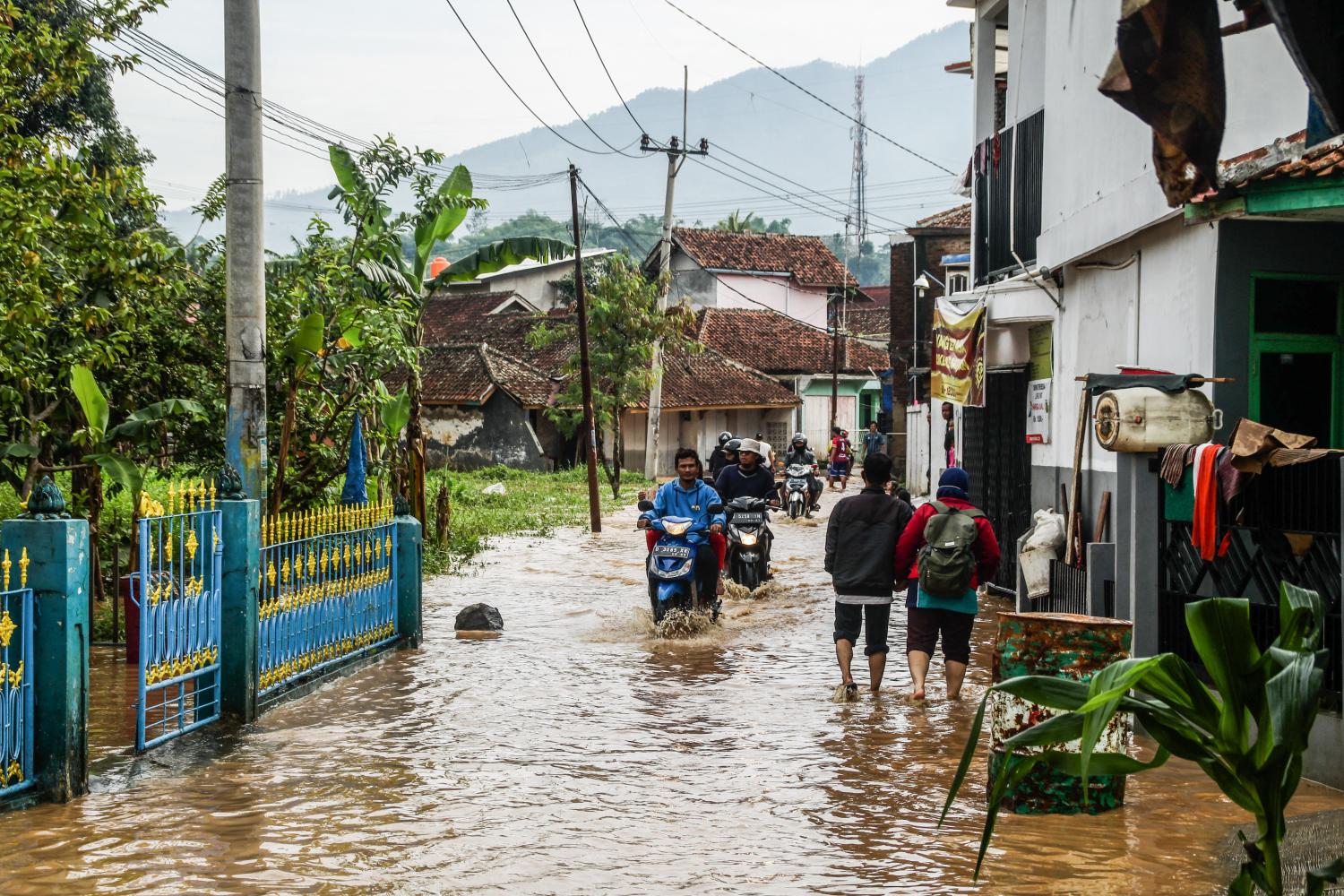 Please ride motorcycles through a flooded road in Cihanjuang Village.Landslides occurred due to heavy rainfall and unstable soil conditions, at least the latest data caused 18 people injured, 12 people died and dozens of others still missing. (Photo by Algi Febri Sugita / SOPA Images/Sipa USA)No Use UK. No Use Germany.