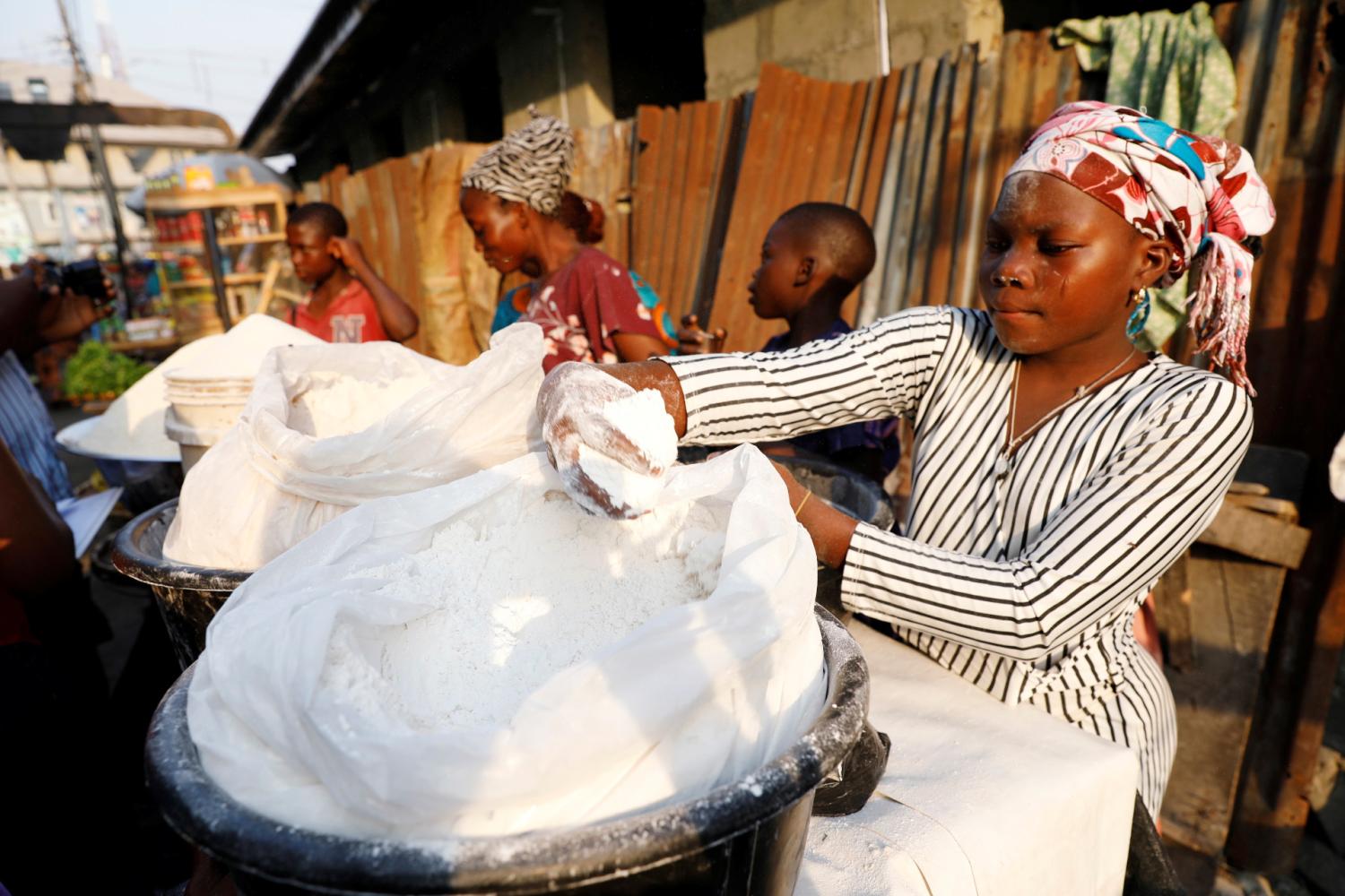 A vendor sells cassava flour at a traditional market in Bariga district, in Lagos, Nigeria January 15, 2021. Picture taken January 15, 2021. REUTERS/Temilade Adelaja