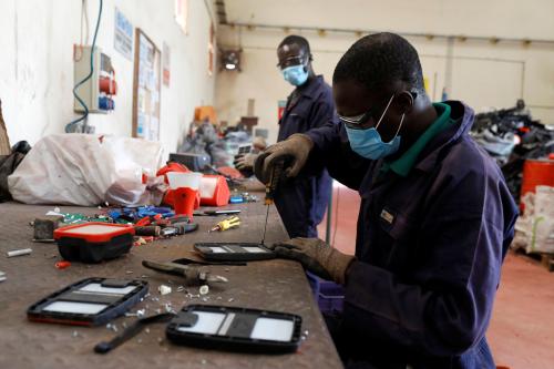 An employee dismantles old solar panels, for e-waste processing, at E-Terra Matter Recovery and Recycling Facility in Festac, Lagos, Nigeria June 19, 2020. Picture taken June 19, 2020. REUTERS/Temilade Adelaja