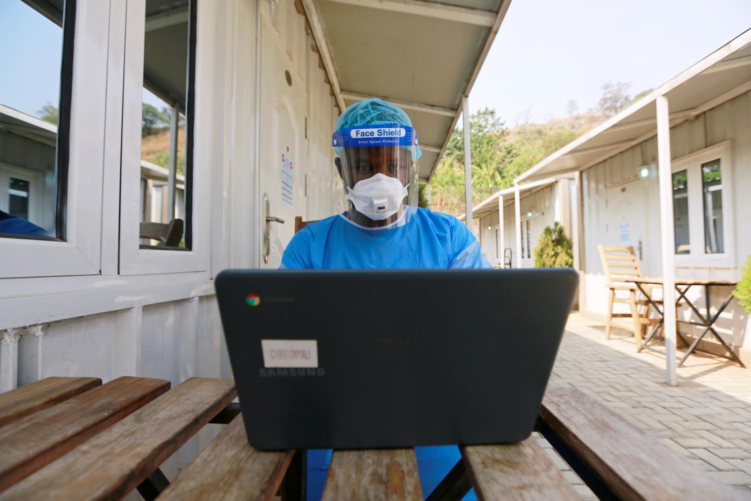 A health professional works on a computer at a drive-through sample collection centre for coronavirus disease (COVID-19) in Abuja, Nigeria January 14, 2021. REUTERS/Afolabi Sotunde
