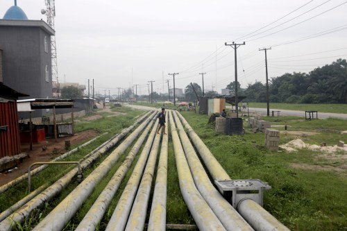 FILE PHOTO: A woman walks over pipelines crisscrossing Ogoniland in Rivers State, Nigeria September 18, 2020. Picture taken September 18, 2020. REUTERS/Afolabi Sotunde/File Photo