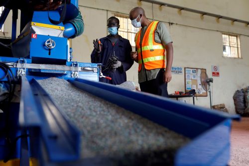 Ifeanyi Ochonogor, chief executive officer of E-Terra Matter Recovery and Recycling Facility, discusses with an employee as they operate a cable shredder machine for e-waste processing, at their facility in Festac, Lagos, Nigeria June 19, 2020. Picture taken June 19, 2020. REUTERS/Temilade Adelaja