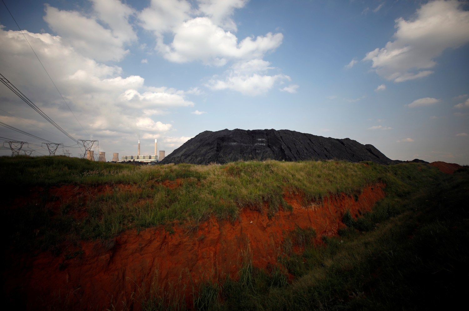 A heap of coal is seen beside a power station owned by state power utility Eskom in Duhva, South Africa, February 18, 2020. Picture taken February 18, 2020. REUTERS/Mike Hutchings
