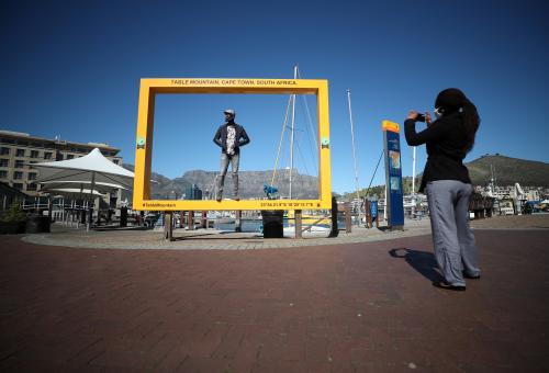 Visitors take photographs at a popular tourist site at the V&A Waterfront during the coronavirus disease (COVID-19) outbreak in Cape Town, South Africa, August 26, 2020. Picture taken August 26, 2020. REUTERS/Mike Hutchings