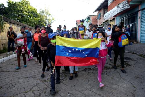 Venezuelan migrants react when members of the Bolivarian National Guard (not pictured) try to stop them on their way to the border between Venezuela and Colombia, during the coronavirus disease (COVID-19) outbreak, in San Cristobal, Venezuela October 12, 2020. Picture taken October 12, 2020. REUTERS/Carlos Eduardo Ramirez