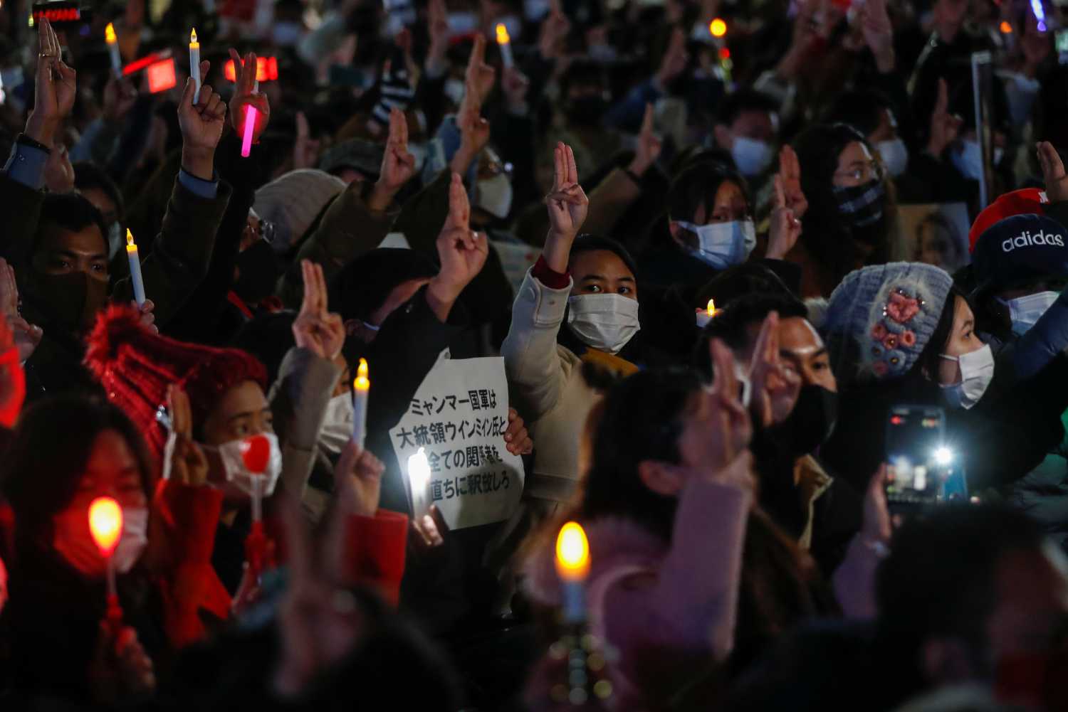 Demonstrators show the three-finger salute as they protest against Myanmar military coup, in Tokyo, Japan, February 11, 2021. REUTERS/Issei Kato