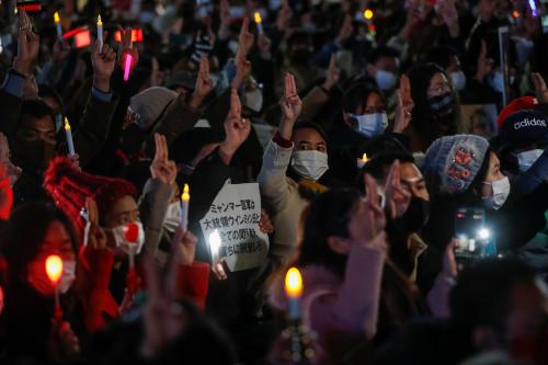 Demonstrators show the three-finger salute as they protest against Myanmar military coup, in Tokyo, Japan, February 11, 2021. REUTERS/Issei Kato