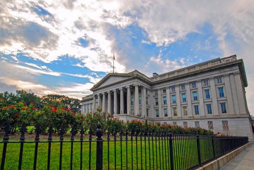 Washington, DC, USA - August 04, 2012: The Treasury Department Federal Credit Union Building with green grass and beautiful flowers in front of it, Pennsylvania Avenue Northwest