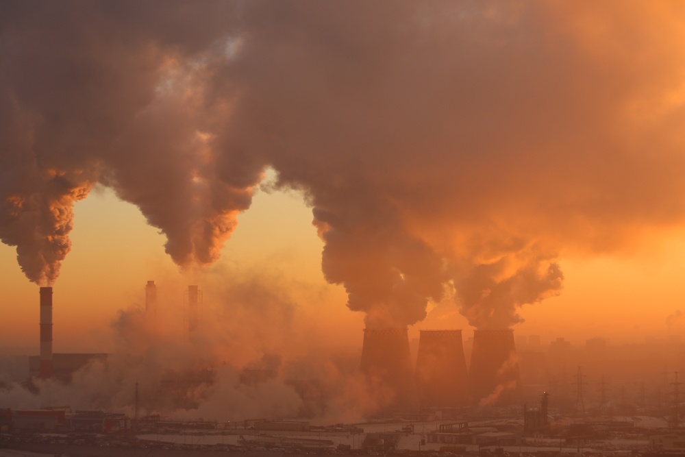 Smoke stacks emitting lots of smoke.