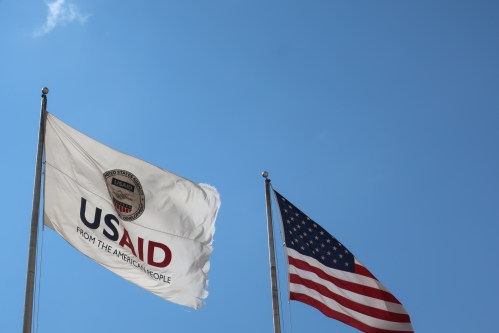 WASHINGTON - AUGUST 2, 2020: USAID Agency for International Development flag with emblem seal outside headquarters building. USAID is the agency that administers foreign aid.