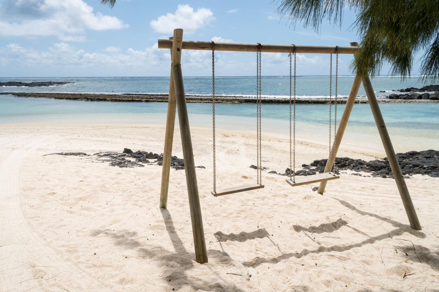 Empty swings on a beach in Mauritius