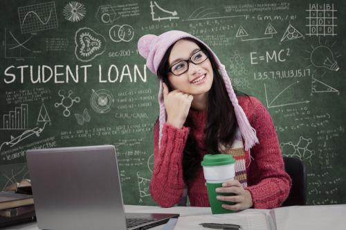 Attractive girl studying in the classroom and dreaming about student loan while wearing winter wear