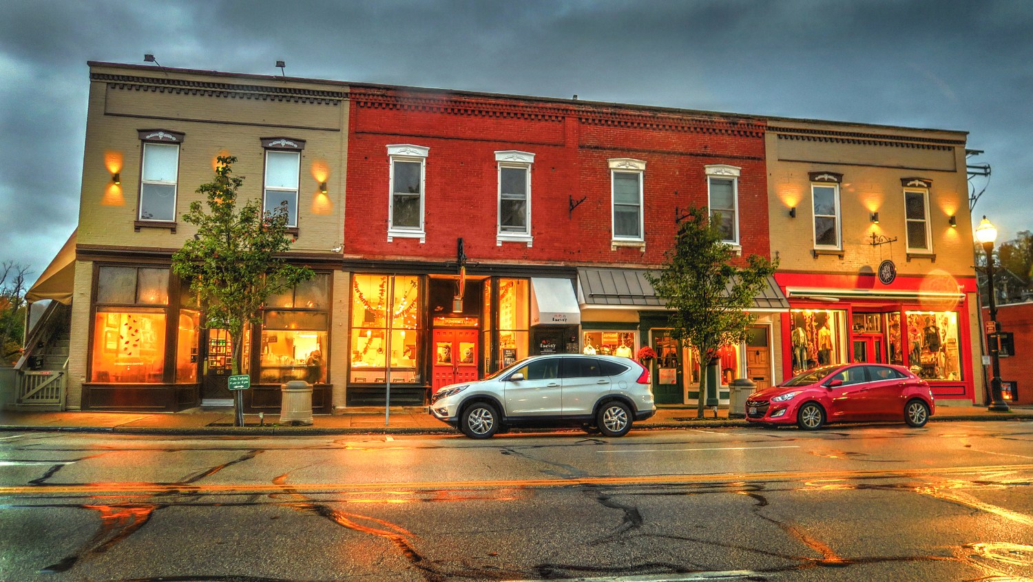 Chagrin Falls, Ohio / USA - October 29, 2017: Rainy Evening View of Starbucks, Jeni's, and Outfitters Shops on Main Street in the Business District of Historical Downtown Chagrin Falls, Ohio