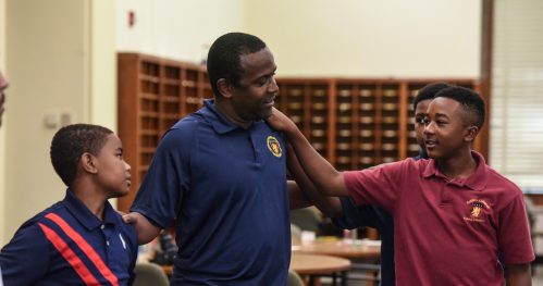 Edwin Avent (C) participates with students in a learning exercise at a summer session of a charter school called Baltimore Collegiate School for Boys in Baltimore, Maryland, U.S., July 30, 2019. Avent co-founded Black Professional Men Inc. in 1991 to lift up African-American men, offering lessons in topics from financial literacy to rap music. Black Professional Men has mentored 3,000 boys and awarded 225 college scholarships, using education and positive reinforcement to divert youth away from gangs, drugs and guns. "What we're doing is building black boys into the next generation of doctors, lawyers, scientists and leaders, maybe even the next Barack Obama," said Avent. REUTERS/Stephanie Keith
