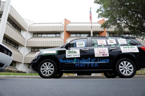 Florida teachers, whose unions are against their members returning to school, hold a car parade protest in front of the Pasco County School district office in Land O' Lakes, Florida, U.S. July 21, 2020.  REUTERS/Octavio Jones