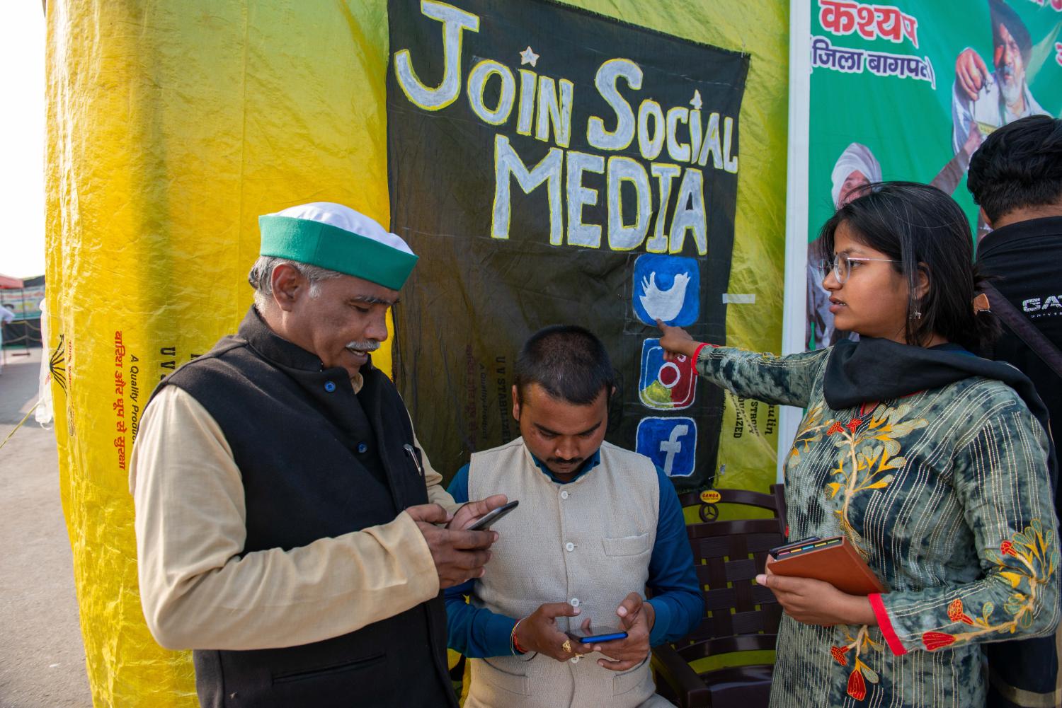 A member of the All India Student Federation teaches farmers about social media and how to use such tools as part of ongoing protests against the government.