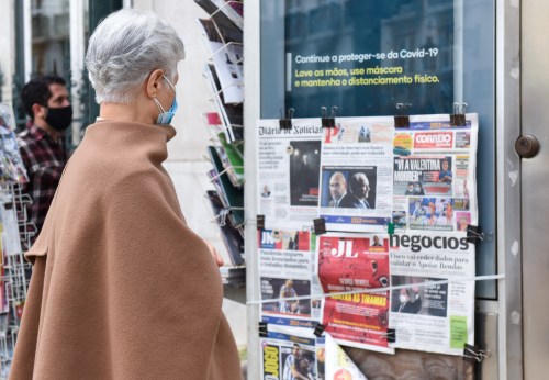 A woman reads the newspapers frontpages at a Chiado newsagent, as Portuguese lockdown continues.Portugal, one of the countries hardest hit by the pandemic, authorised the renewal of the state of emergency until March 1st, to try to contain the coronavirus pandemic. (Photo by Gustavo Valiente Herrero / SOPA Images/Sipa USA)No Use Germany.