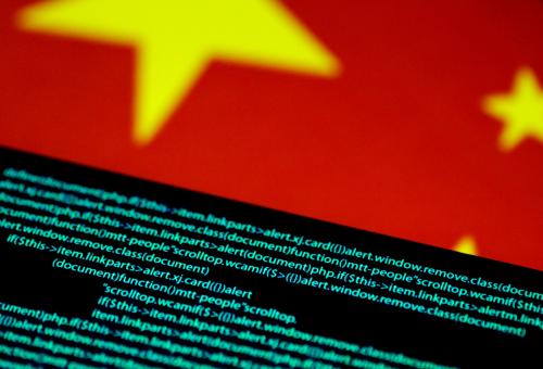 FILE PHOTO: Computer code is seen on a screen above a Chinese flag in this July 12, 2017 illustration photo.   REUTERS/Thomas White/Illustration/File Photo