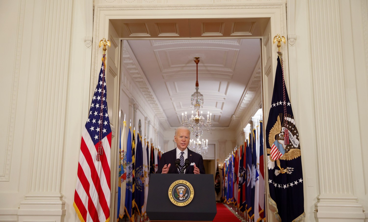 U.S. President Joe Biden delivers his first prime time address as president, marking the one-year anniversary of widespread shutdowns to combat the coronavirus disease (COVID-19) pandemic and speaking about the impact of the pandemic from the East Room of the White House in Washington, U.S., March 11, 2021. REUTERS/Tom Brenner