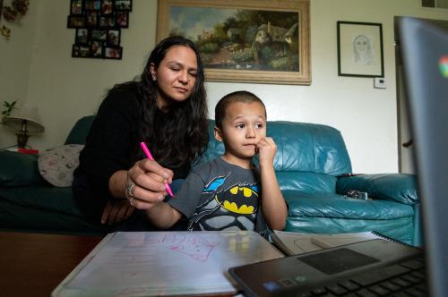 Rosario Correa, 34, and her son Michael Gamino Correa, 5, participate in his school Zoom class at home on Thursday, March 18, 2021 in Sacramento. The single Latina mother changed her work schedule to a night shift to help supervised her three childrenís schooling during the day. (Paul Kitagaki Jr./Sacramento Bee/TNS/ABACAPRESS.COM - NO FILM, NO VIDEO, NO TV, NO DOCUMENTARY