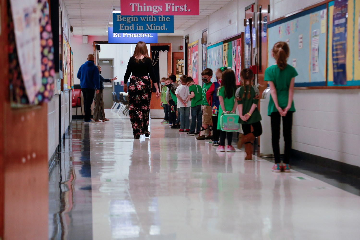 Students stand 2 feet apart as they practice social distancing before walking into the cafeteria on the first day back to school after coronavirus disease (COVID-19) restrictions were adjusted, in Louisville, Kentucky,
