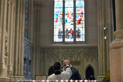 A seminarian places ash on the forehead of a church goer inside St. Patricks Cathedral on Ash Wednesday in New York, NY, February 17, 2021. (Photo by Anthony Behar/Sipa USA)No Use Germany.
