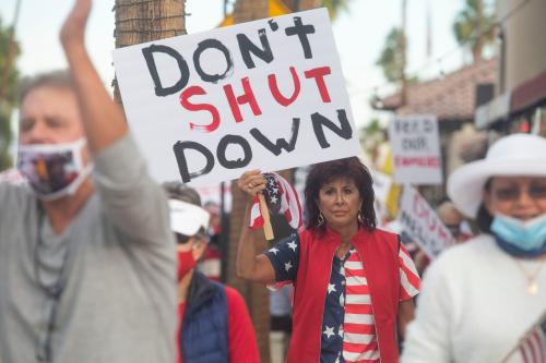 Community members march down El Paseo shopping district in Palm Desert in rebuke of the shutdown mandate by the state government to stop the spread of COVID-19 on December 9, 2020.Coivd Protest