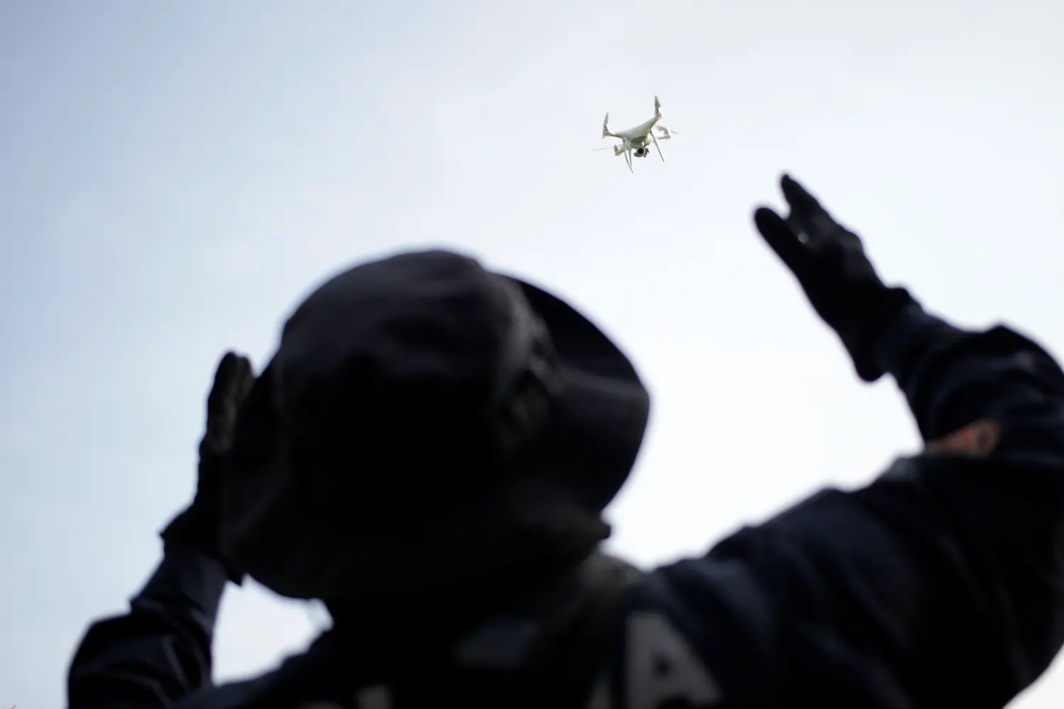 A police officer uses a drone during a search for skeletal remains and clothing at a plot of land, in the municipality of Hidalgo, on the outskirts of Monterrey, Mexico September 3, 2020. REUTERS/Daniel Becerril