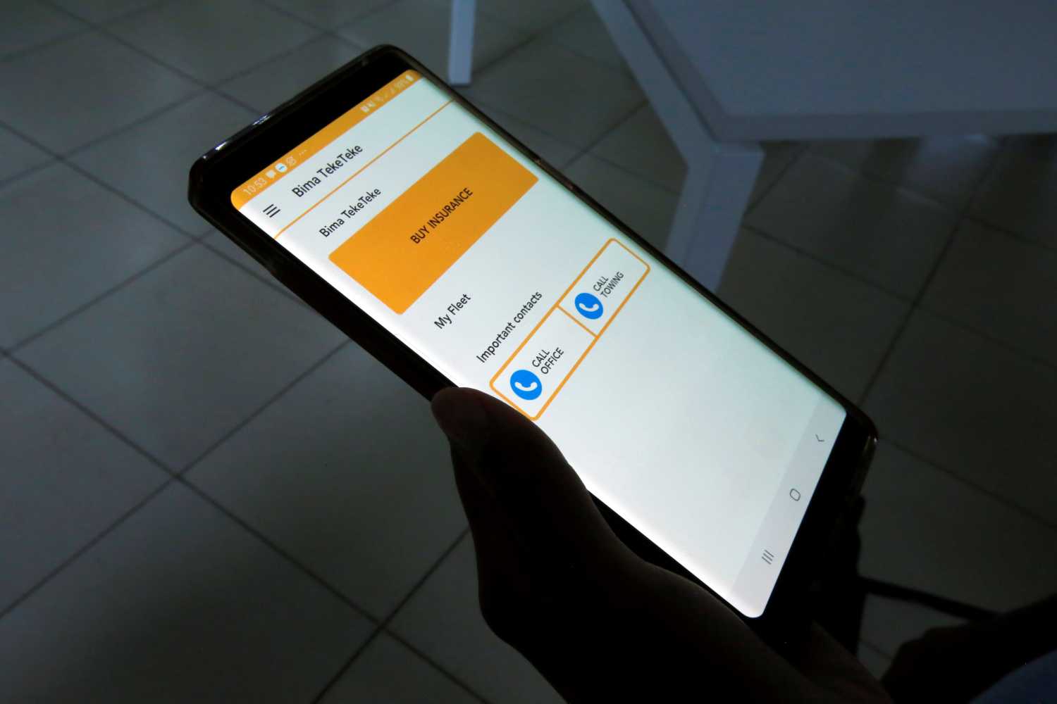 Jihan Abass, founder and CEO of Griffin Insurance, holds her phone as she displays an insurance product under Griffin Motor app as they prepare to release their flagship digital-only car insurance company, in Nairobi, Kenya January 24, 2020. REUTERS/Jackson Njehia