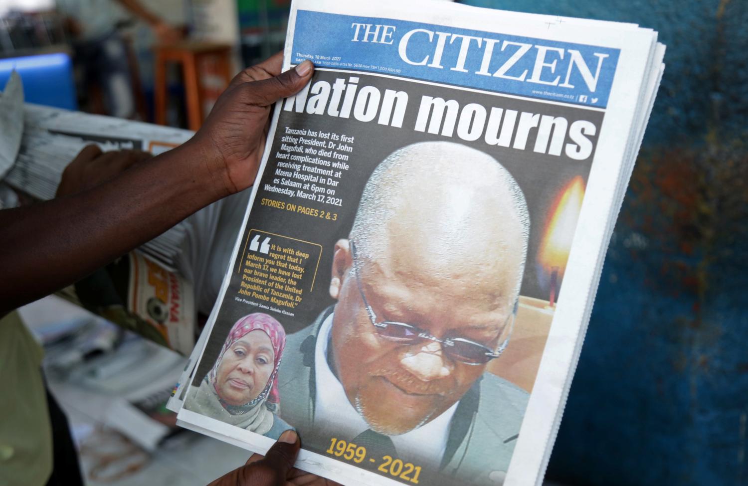 A man holds a newspapers following the death of Tanzania's President John Magufuli in Dar es Salaam, Tanzania March 18, 2021. REUTERS/Emmanuel Herman