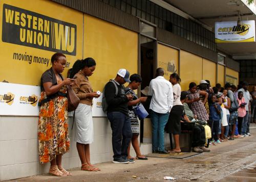 Zimbabweans queue outside a Western Union branch in Harare, Zimbabwe, February 26, 2019. REUTERS/Philimon Bulawayo