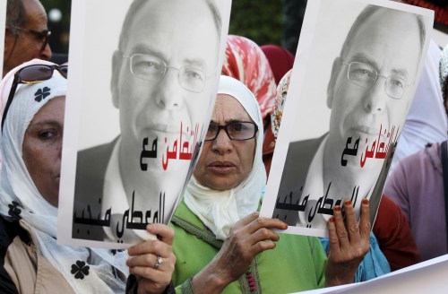 Moroccan protesters hold up posters of Maati Monjib, a Moroccan professor of political history, to support him during a demonstration in the capital, Rabat, October 21, 2015. Monjib started a second hunger strike last Wednesday after authorities banned him from boarding a plane to Norway for an international conference on journalism in Lillehammer. The sign reads, "Even if you use repression, your intimidation is useless". REUTERS/Stringer