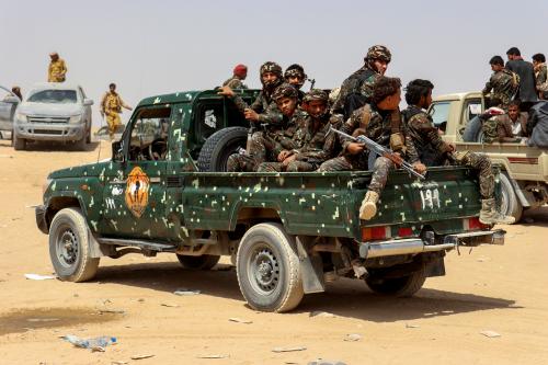 Soldiers ride on the back of a patrol truck during the burial of Brigadier General Abdul-Ghani Shaalan, Commander of the Special Security Forces in Marib who was killed in recent fighting with Houthi fighters in Marib, Yemen February 28, 2021. REUTERS/Ali Owidha