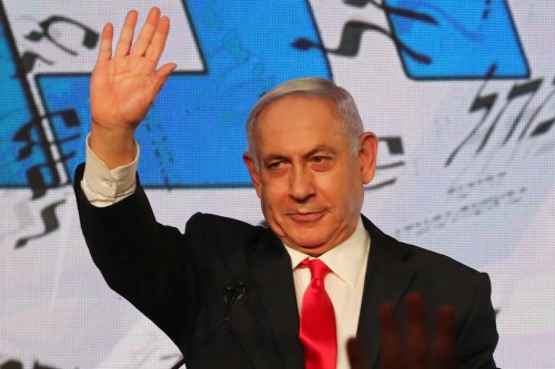 Israeli Prime Minister Benjamin Netanyahu gestures as he delivers a speech to supporters following the announcement of exit polls in Israel's general election at his Likud party headquarters in Jerusalem March 24, 2021. REUTERS/Ammar Awad