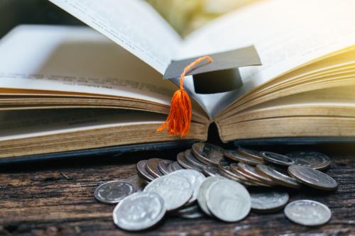 book, coins, and graduation cap