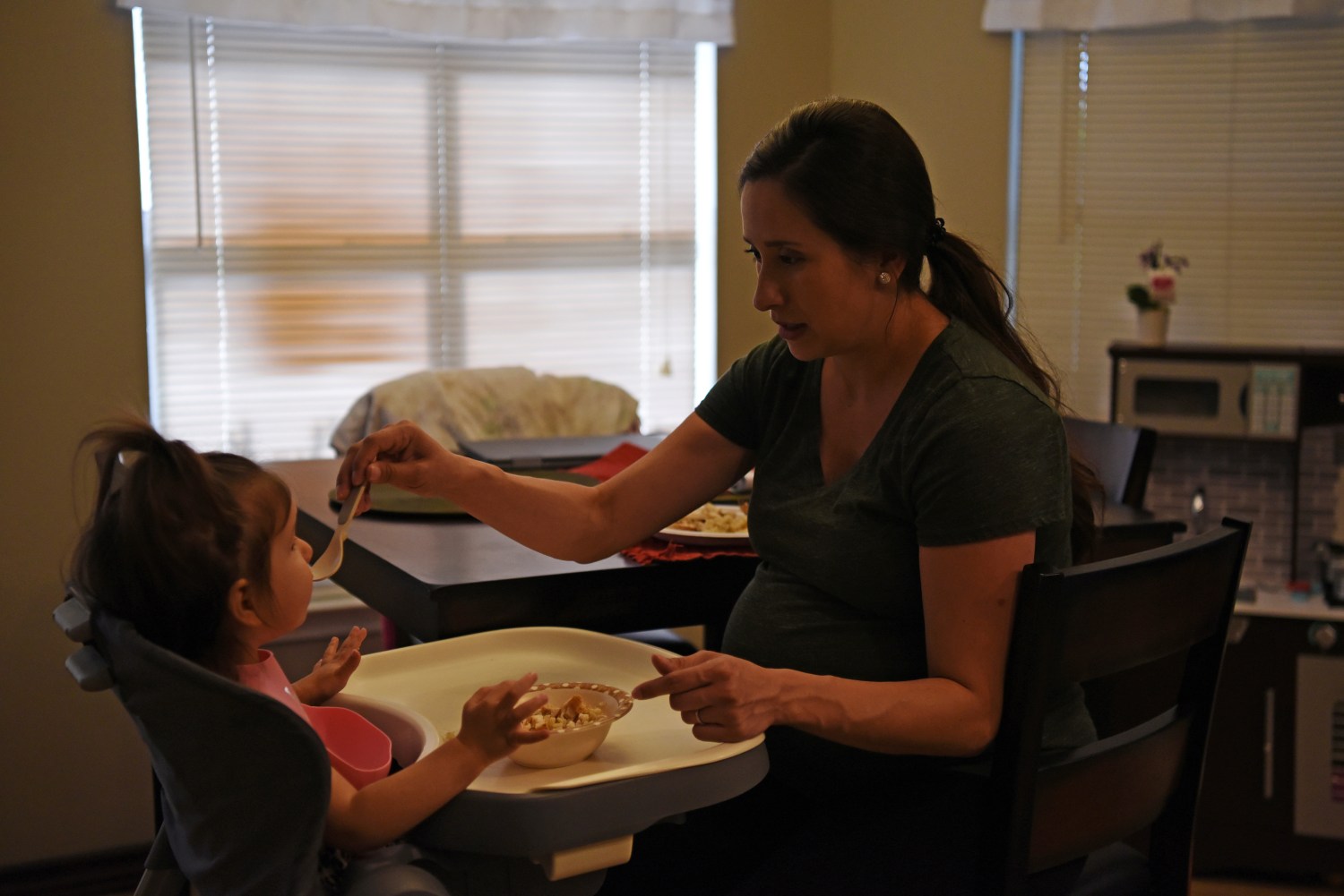 Pregnant nurse Samantha Salinas feeds her daughter, Macie, amid a coronavirus disease (COVID-19) outbreak in San Antonio, Texas, U.S., May 6, 2020. Picture taken May 6, 2020.  REUTERS/Callaghan O'Hare