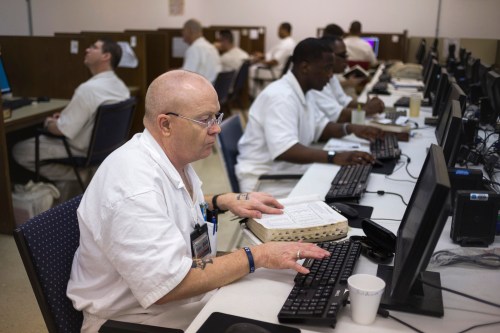 Offenders research and work on their papers inside the Southwestern Baptist Theological computer lab located in the Darrington Unit of the Texas Department of Criminal Justice men's prison in Rosharon, Texas August 12, 2014. The Southwestern Baptist Theological Seminary, a private college based in Fort Worth, Texas, began its bachelor of science in biblical studies program at Darrington, south of Houston, about three years ago. To be accepted, an offender has to be at least 10 years from the possibility of parole, have a good behavior record and the appropriate academic credentials to enroll in a college course. The program, which is largely paid for by charitable contributions from the Heart of Texas Foundation, has more than 150 prisoners enrolled and plans to send its graduates as field ministers to other units who want the bible college alumni for peer counseling and spiritual guidance. The first degrees are expected to be conferred next year. Picture taken August 12, 2014. To match Feature USA-TEXAS/PRISON     REUTERS/Adrees Latif (UNITED STATES - Tags: CRIME LAW EDUCATION SOCIETY RELIGION)