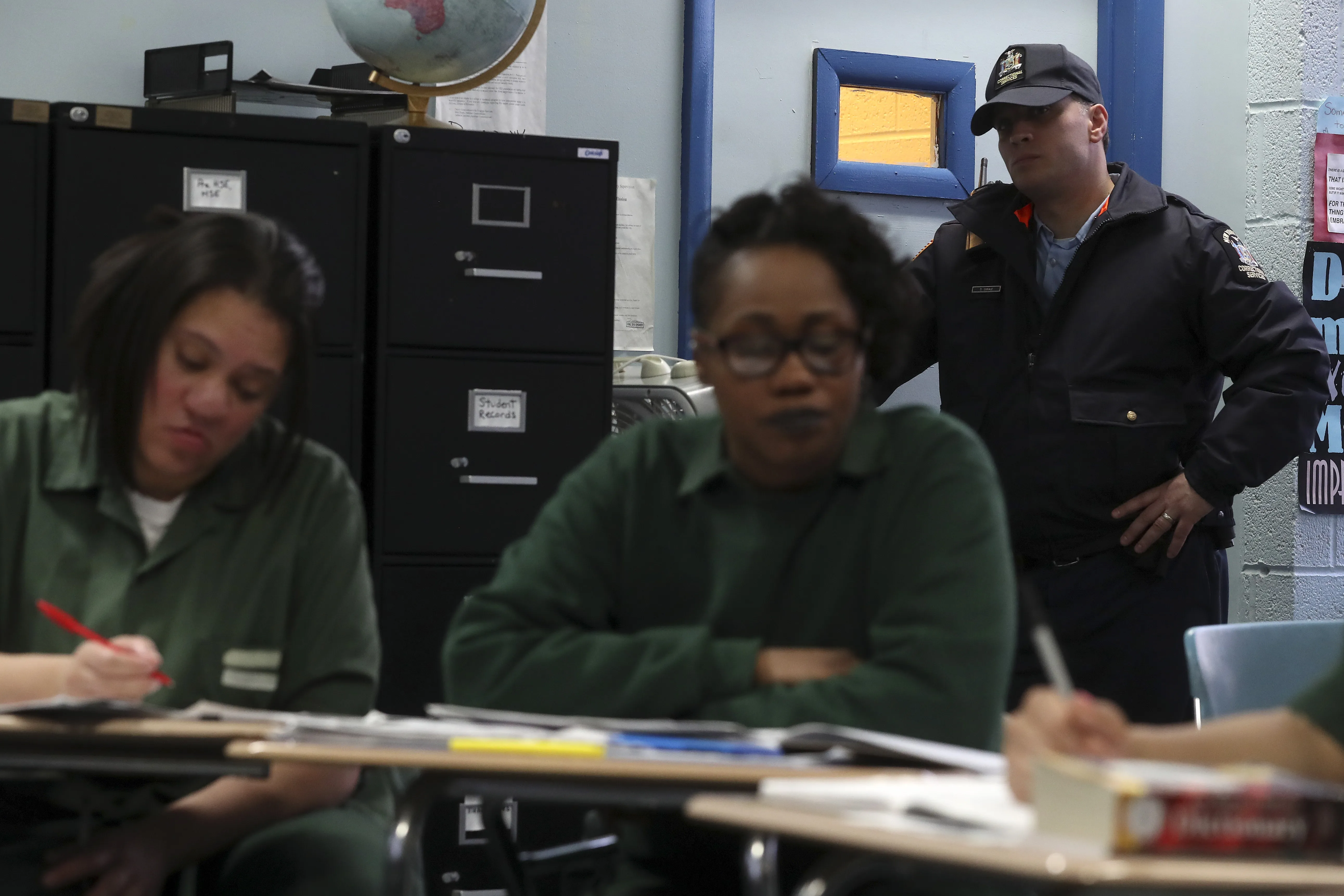 A prison guard keeps watch during class at the Taconic Correctional Facility in Bedford Hills, New York April 8, 2016. Inmates at Taconic Correctional Facility, a medium security women's prison in suburban Bedford Hills near New York City, are reading the classic works of Homer, Euripides and Virgil. The Columbia University course, organised by the non-profit Hudson Link for Higher Education in Prison, aims to boost employment for convicts after release and reduce rates of reoffending. REUTERS/Carlo Allegri SEARCH "TACONIC ALLEGRI" FOR THIS STORY. SEARCH "THE WIDER IMAGE" FOR ALL STORIES   TPX IMAGES OF THE DAY