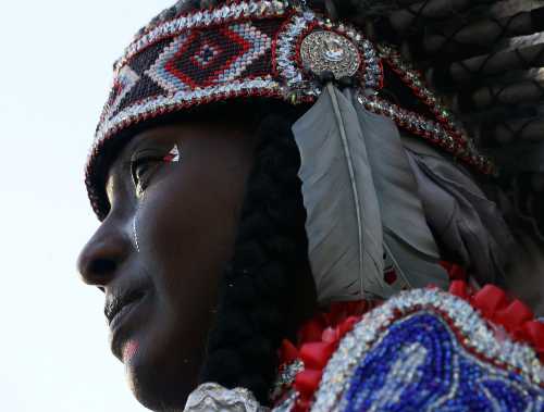 Tonya Johnson, Big Queen of the Wild Tchoupitoulas Indian Tribe, who went to high school with Baton Rouge police officer Montrell Jackson, who was shot and killed Sunday morning, attends a vigil in Baton Rouge, Louisiana, U.S. July 19, 2016.  REUTERS/Jonathan Bachman