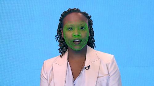 A green wireframe model covers an actor's lower face during the creation of a synthetic facial reanimation video, known as a deepfake.