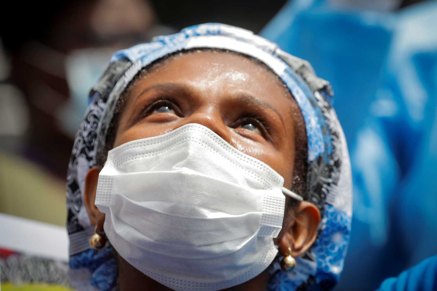 A member of the 1199SEIU union, the nation's largest healthcare workers' union, kneels for eight minutes and 46 seconds of silence, during a vigil and walkout action at Brookdale Hospital Medical Center in a protest against racial inequality in the Brooklyn borough of New York City, U.S., June 11, 2020.  REUTERS/Brendan McDermid