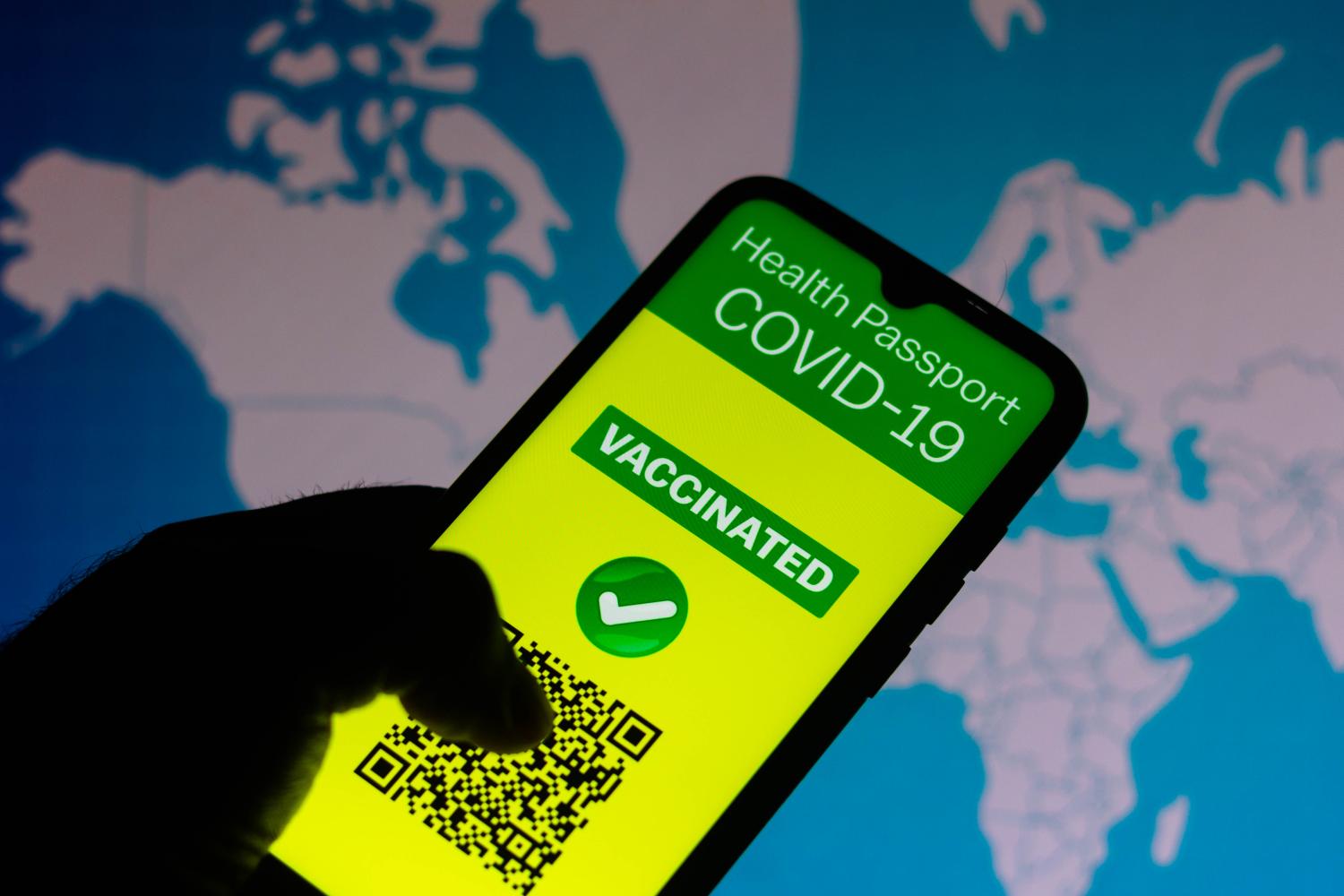 A vaccination passport application for COVID-19 is displayed on a smartphone.